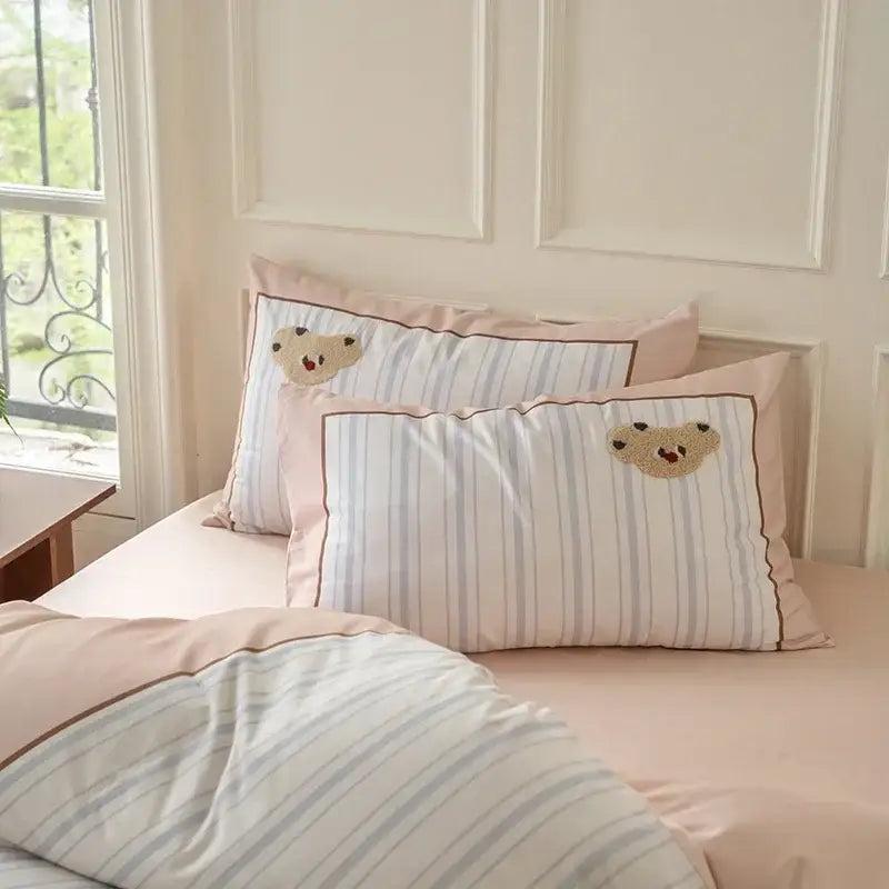 Pastel pink and light blue striped pillowcases with embroidered bear faces in decorbites cotton embroidered bedding set