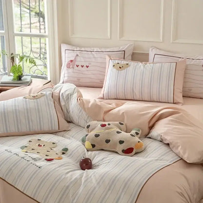 Pastel pink and light blue striped decorbites cotton embroidered bedding set with animal motifs on pillows for bedroom decor