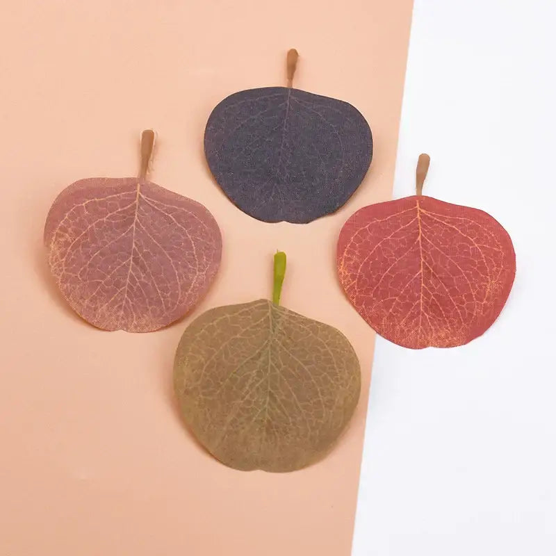 Four decorative pressed leaves in muted pink, purple, red, and brown tones silk leaf artificial plants for home decor