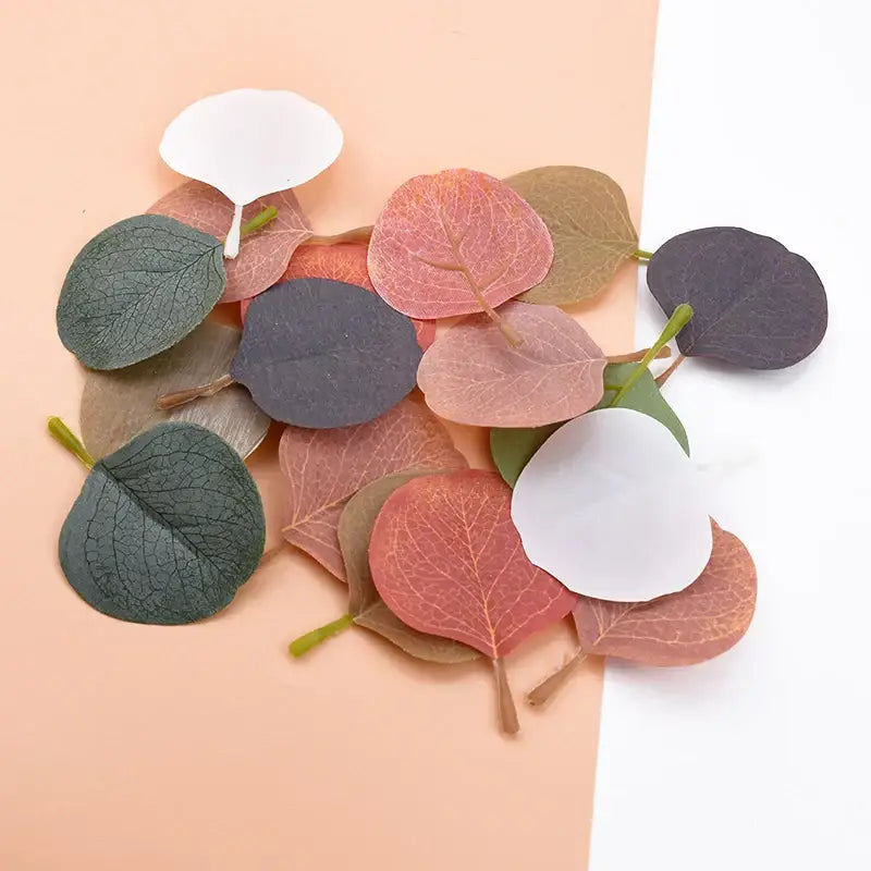 A collection of pastel pink and green silk leaf artificial plants for living room home decor with soft eucalyptus leaves