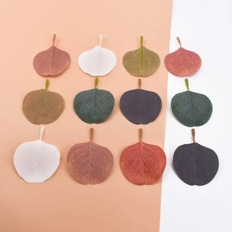 A collection of silk leaf artificial plants in pastel pink green and earth tones for elegant home decor