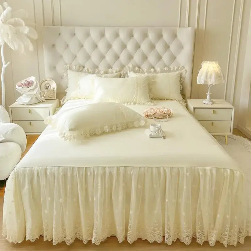 Cream-colored lace bed skirt with flowing ruffled hem and floral embroidery for pastel pink lace bed sheet set