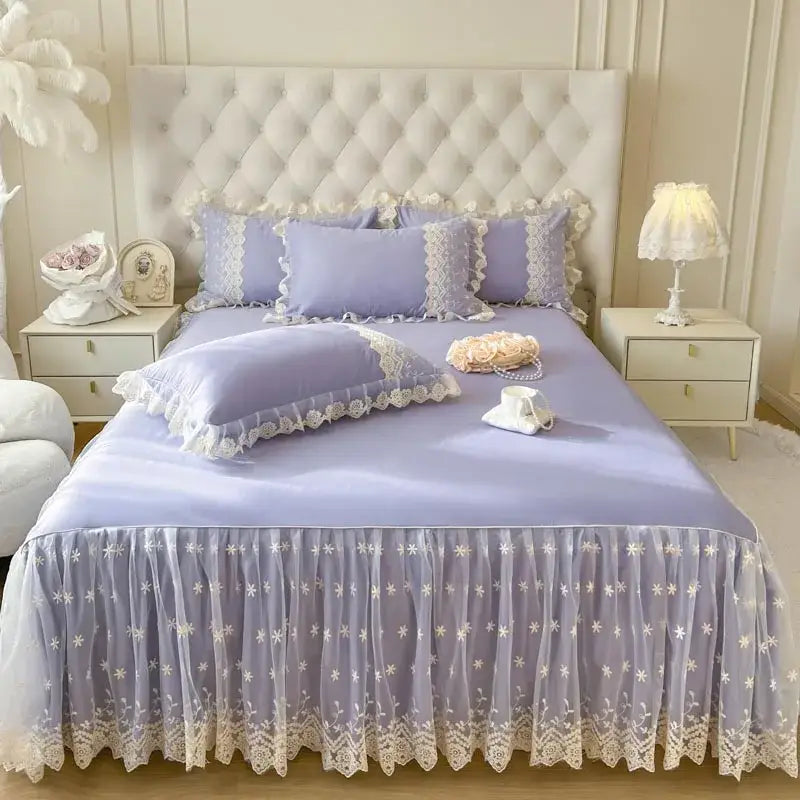 Lavender-colored bed sheet set with delicate white lace trim and floral embroidery in a pastel pink lace ruffled design