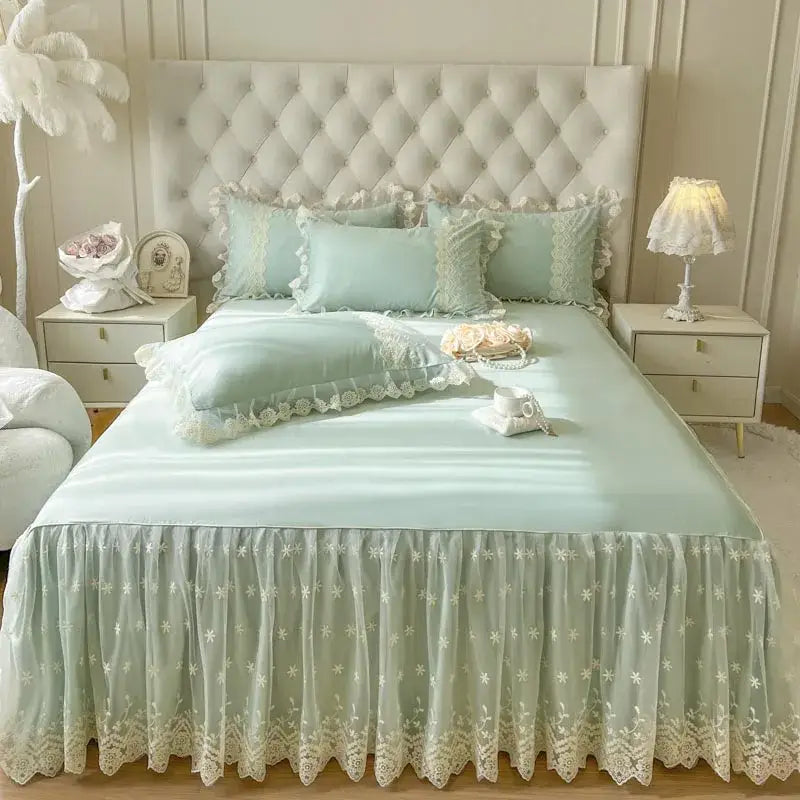 Pastel pink lace ruffled bed sheet set with mint green lace ruffled bed skirt featuring floral embroidery and scalloped edges
