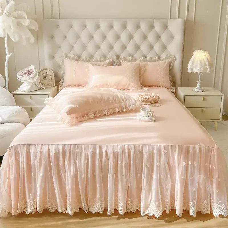 Pastel pink lace ruffled bed sheet set with delicate lace trim and subtle floral embroidery for bedroom use