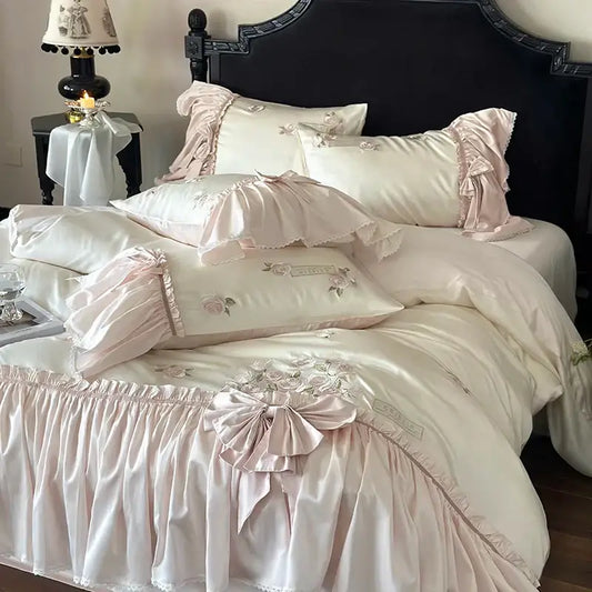 Pastel pink satin bedding set with ruffle flower embroidery and delicate floral lyocell trim for luxury bedroom use