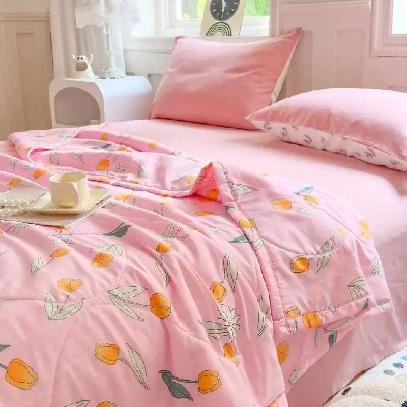 Pastel pink and white cartoon bear printed summer quilt with pink quilted comforter featuring orange tulips decorbites cartoon bear
