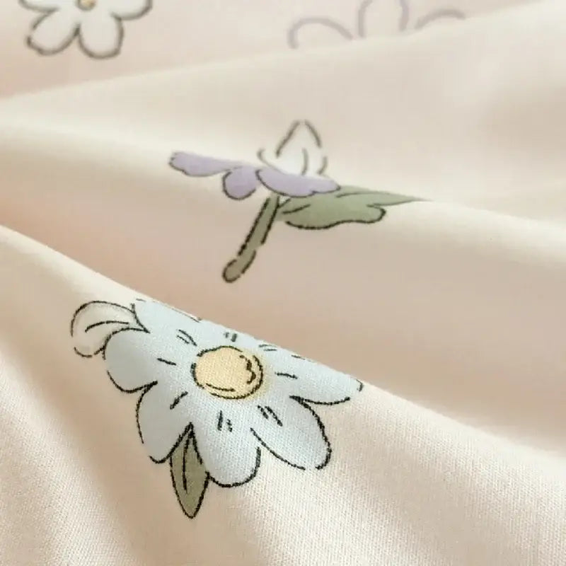 Soft cream fabric with hand-drawn floral pattern on pastel pink and white cartoon bear printed summer quilt blanket decorbites cartoon bear