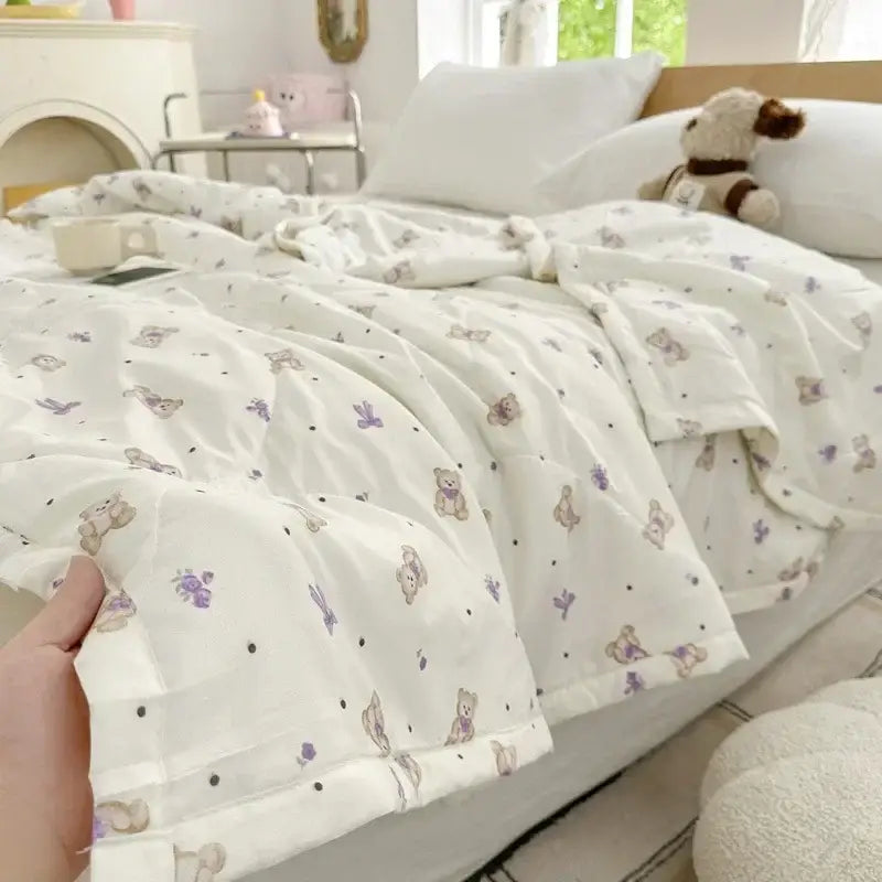 A soft white duvet cover with pastel cartoon bear printed pattern and subtle black polka dots for bedroom decor