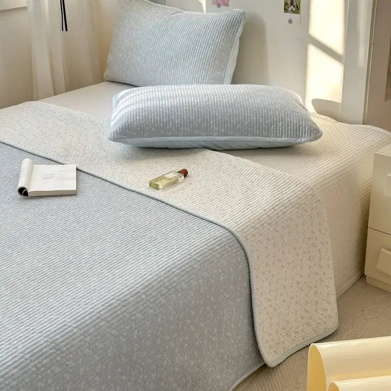 Light blue quilted cotton bed cover with subtle floral pattern and soft texture for tatami mat bedroom use