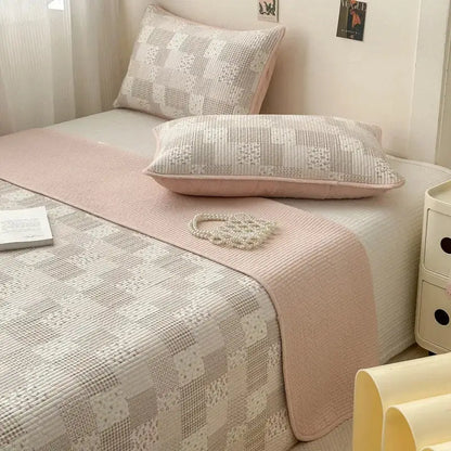 Pink quilted cotton bed cover with a subtle textured pattern used as a soft anti-slip tatami mat runner