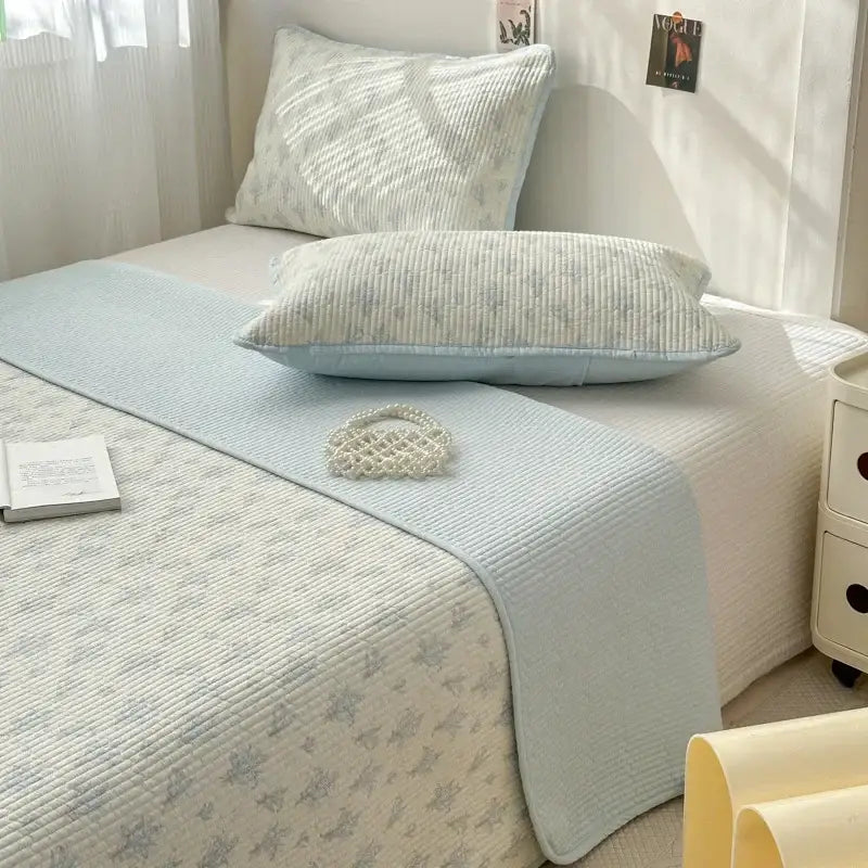 Light blue quilted cotton bed cover with subtle floral pattern designed as a soft anti slip tatami mat runner
