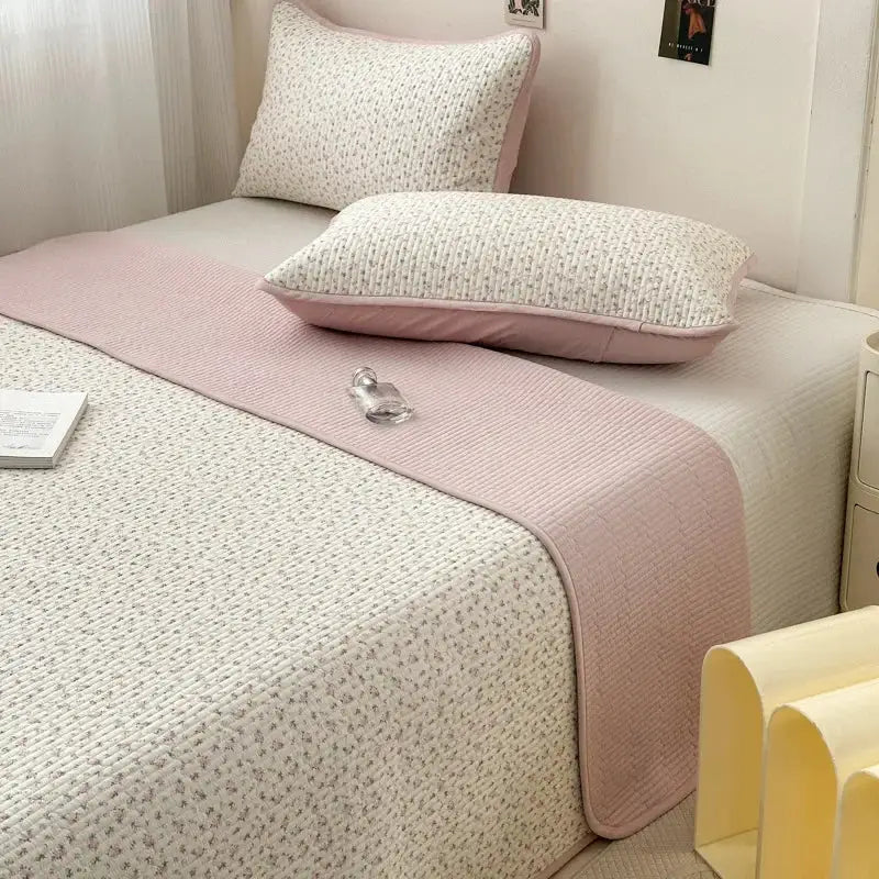 Pink quilted cotton bed cover with subtle floral pattern designed as a soft anti slip tatami mat runner