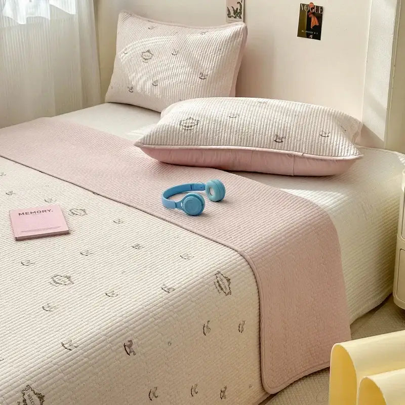 Soft pink quilted cotton bed cover with subtle embroidery ideal for a pastel tatami mat and bedroom use