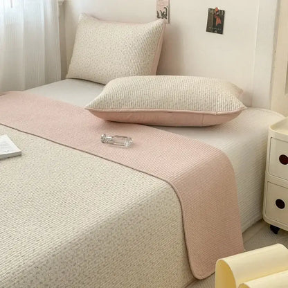 Soft pink cotton bed cover with subtle woven pattern and anti-slip texture for tatami mat bedrooms