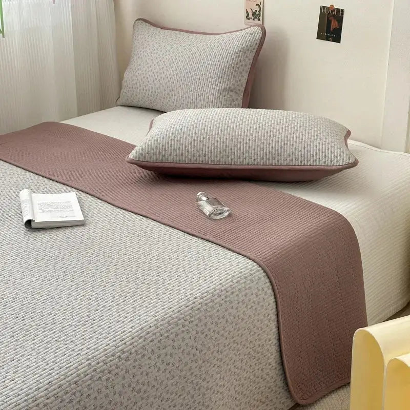 A soft mauve quilted cotton bed cover with subtle woven pattern suitable as a cotton bed tatami mat runner