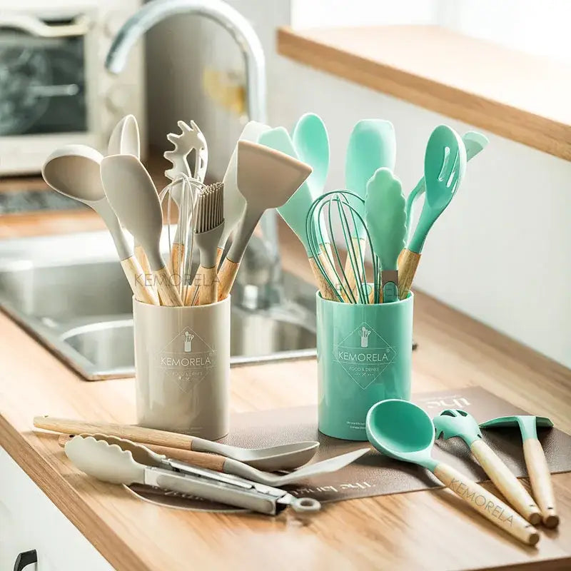 Pastel silicone kitchen utensils set with beige and mint green silicone kitchen utensils organized in ceramic cups