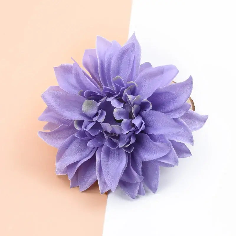 A delicate lavender silk gerbera decorative flower hair clip with layered petals for wedding and home decor
