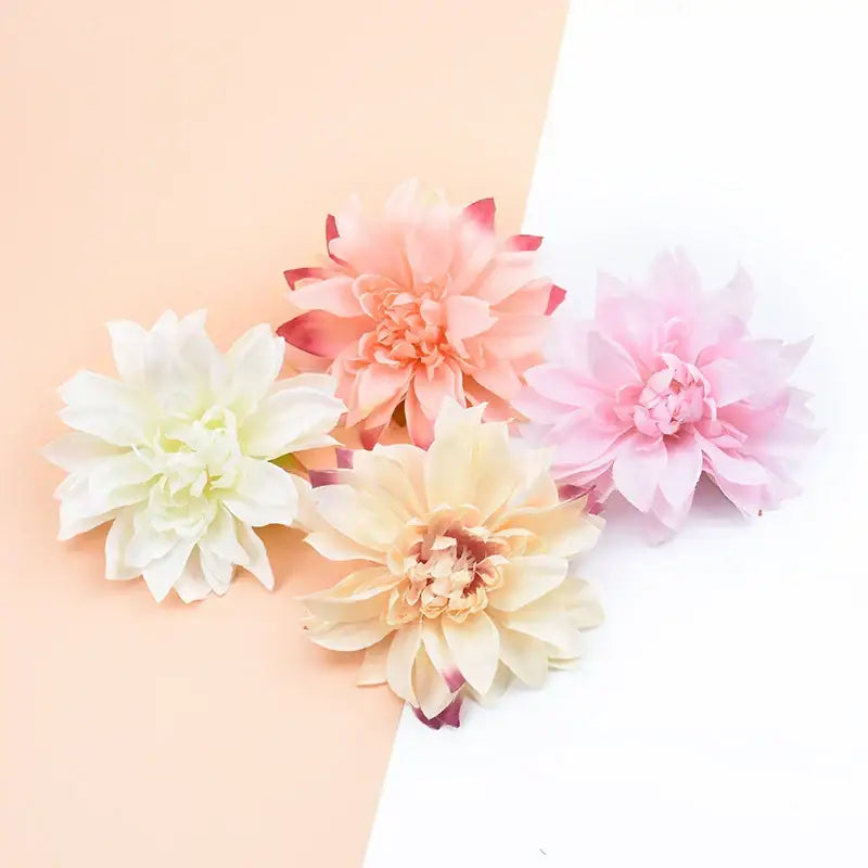 A set of four pastel silk gerbera decorative flowers in white, peach, and pink with layered petals for home decor