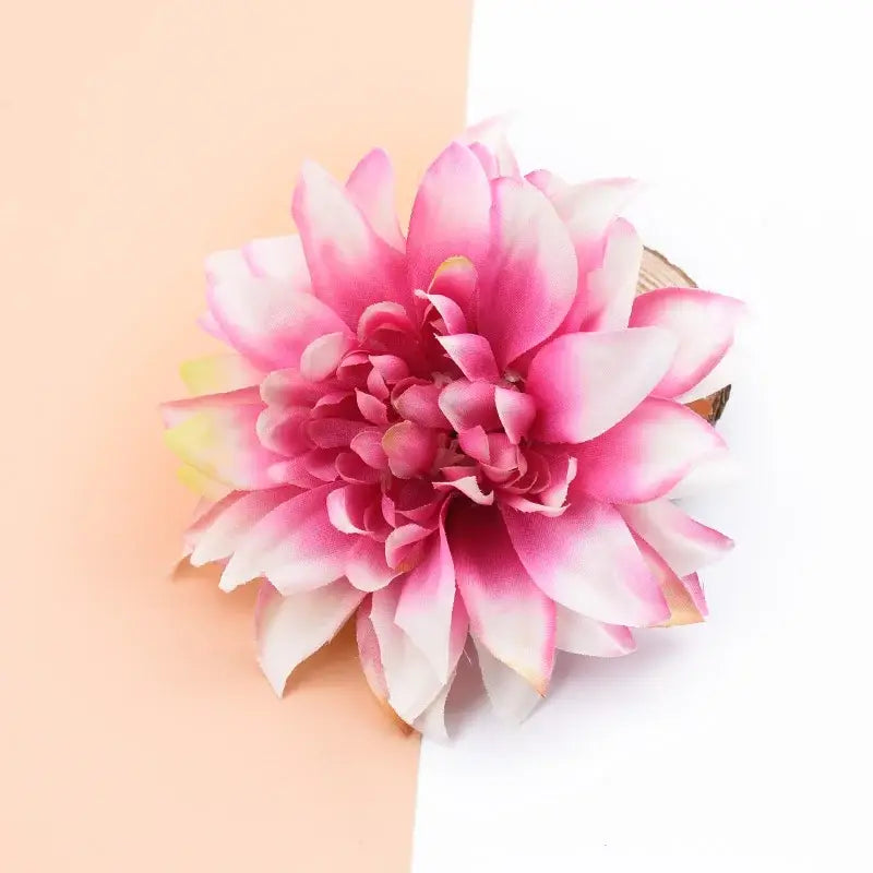A vibrant pink and white silk gerbera decorative flower with layered petals for wedding home decor