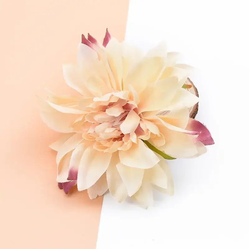 A delicate peach-colored silk gerbera flower with soft layered petals and subtle pink tips for wedding decor