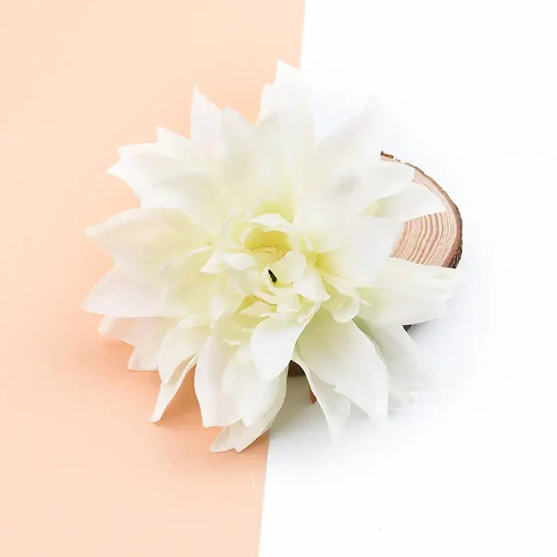 A delicate white silk gerbera flower with layered petals and lifelike texture for wedding and living room decor
