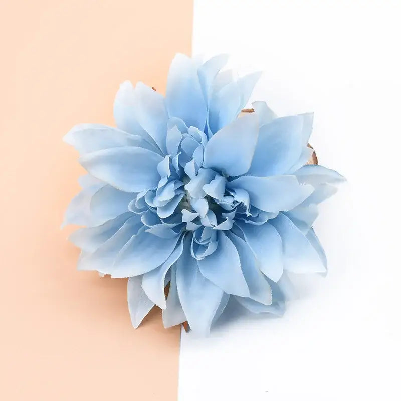 A delicate light blue artificial silk gerbera flower with layered soft petals for wedding and living room decor