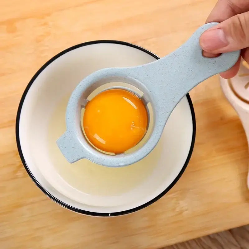 Pastel star perforated light blue speckled plastic egg white separator holding a vibrant orange yolk for easy separation