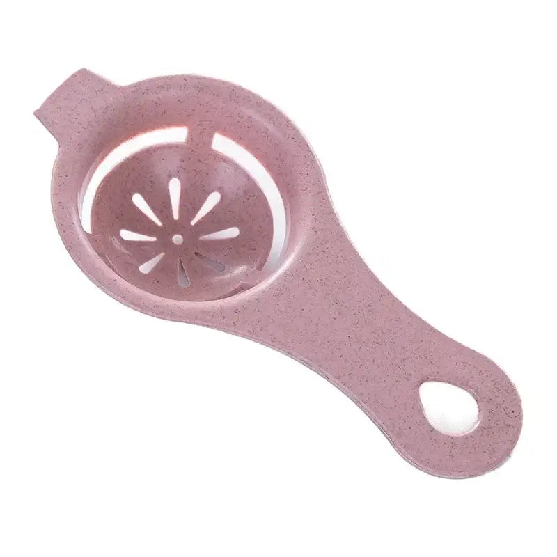 Pink speckled plastic egg white separator with star-shaped perforations and an oval handle cutout for kitchen use