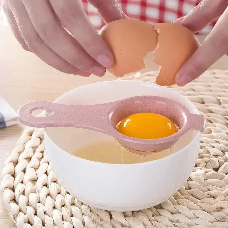 Pastel star pink plastic egg white separator with perforations holding a single yolk over a white bowl