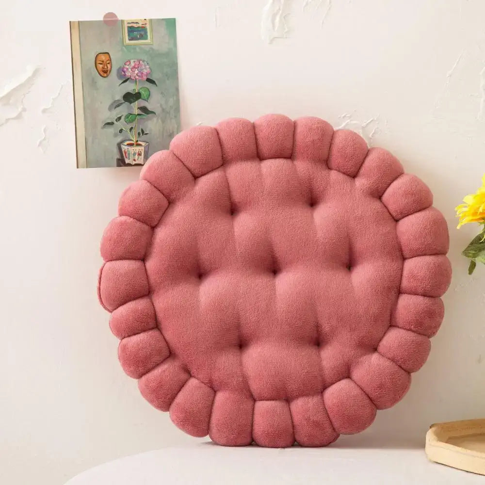 A plush round pink cookie biscuit cushion with tufted center and scalloped edge for soft living room decorbites decor