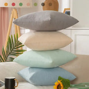 Stack of four pastel velvet rectangular pillow covers in gray beige mint green and light blue pillow cover set for living room decor