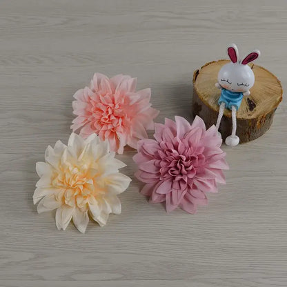 Three artificial woolen chrysanthemum wreath bouquet flowers in pastel pink, peach cream, and muted rose for wedding decor