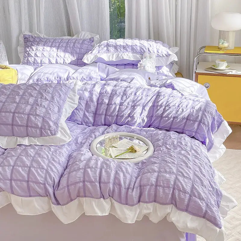 Lavender quilted bedding set with white ruffled trim and matching pillows made from decorbites bubble cotton lace