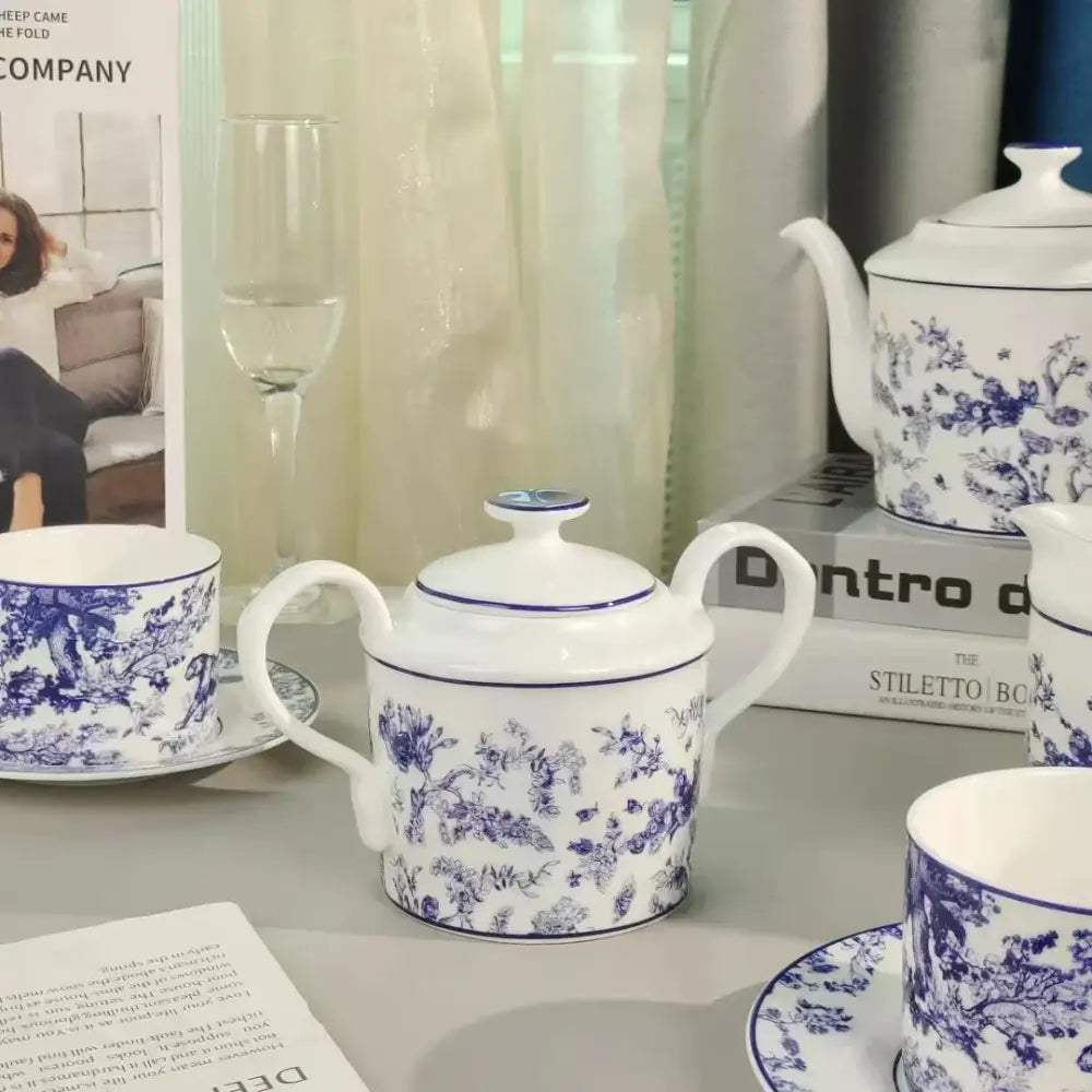 White ceramic teapot with intricate blue floral patterns and matching lid from decorbites jungle lion bone tea set