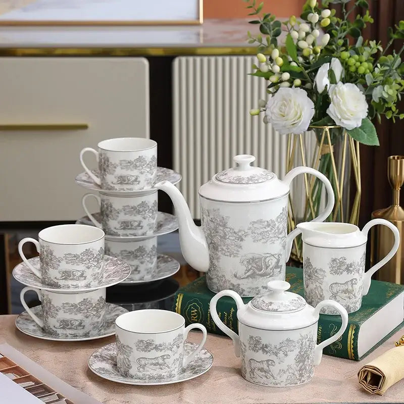White porcelain tea set with gray pastoral scene patterns and gold trim from decorbites jungle lion bone collection