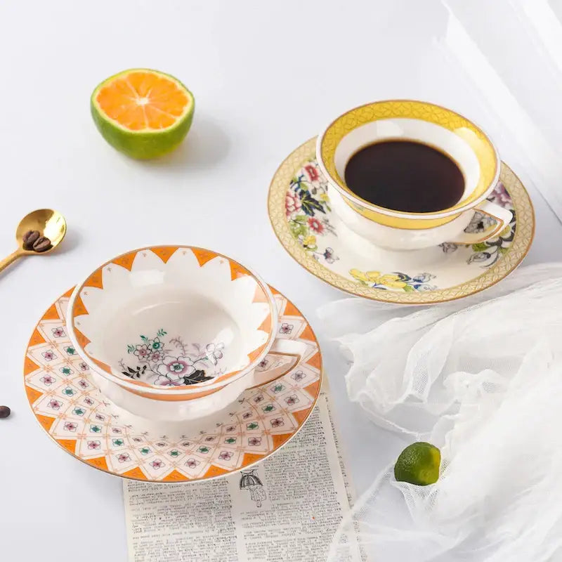 White porcelain pastoral floral bone china flower coffee cup with gold rim and matching orange geometric coffee cup saucers for tea time