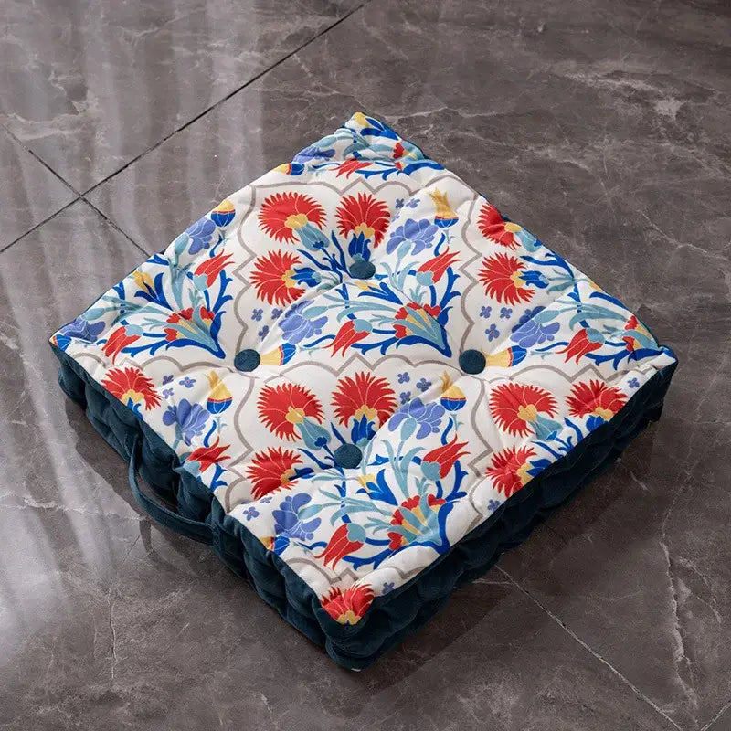 Square floor cushion with vibrant red blue yellow floral pattern and dark teal velvet trim for decorbites bohemian mandala reading nook decor