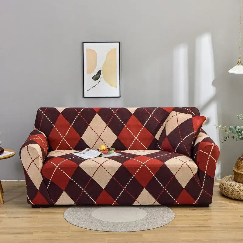 A cozy sofa with a stretchy argyle-patterned patchwork mandala printed slipcover in bold red and beige tones
