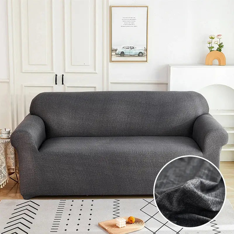 Dark gray textured fabric stretch sofa cover with subtle woven pattern for living room slipcover use