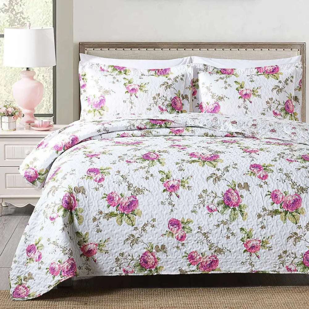 White quilted coverlet bedding set with pink rose floral pattern and green foliage featuring soft textured surface