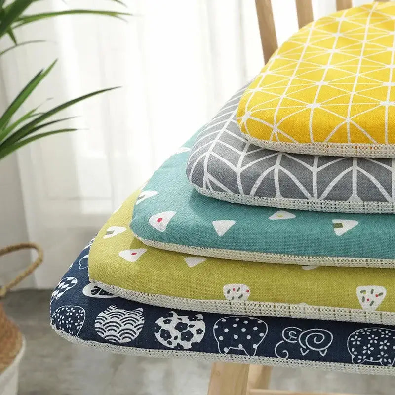Stack of colorful dining chair cushions in yellow gray teal lime green and navy decorbites cotton hemp fabric