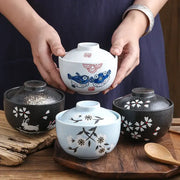 White ceramic stew pot bowl with blue fish and red dot patterns and a matching lid for dining room use