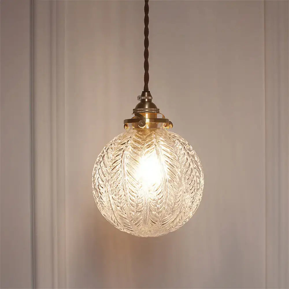Clear intricately etched glass globe pendant ceiling light with brass fixture and twisted brown cord pauline modern industrial sphere