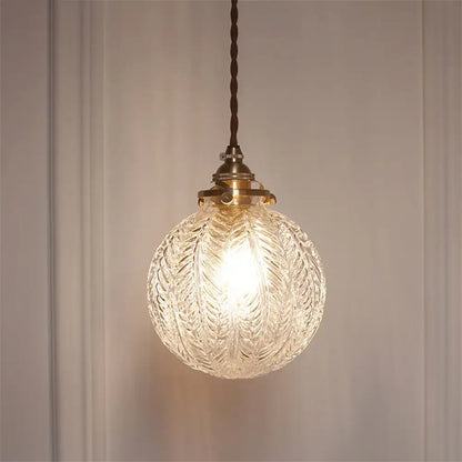 Clear intricately etched glass globe pendant ceiling light with brass fixture and twisted brown cord pauline modern industrial sphere