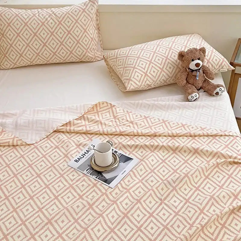 Peach and cream geometric bed sheet set with soft textured fabric finish in beige and cream tones