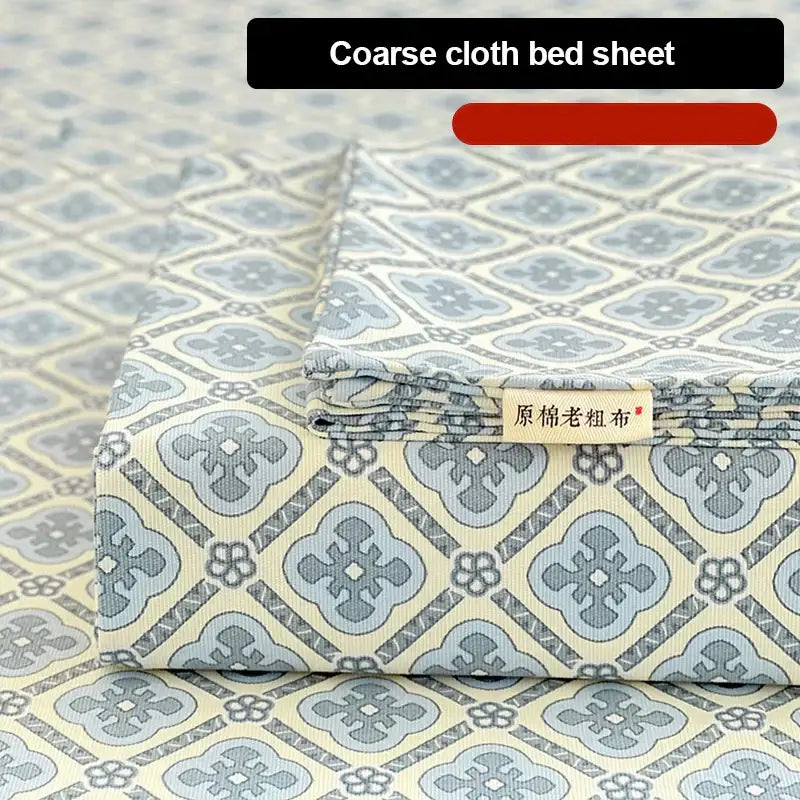 Peach and cream geometric bed sheet set with coarse textured cotton fabric and embroidered label in muted blue and cream tones