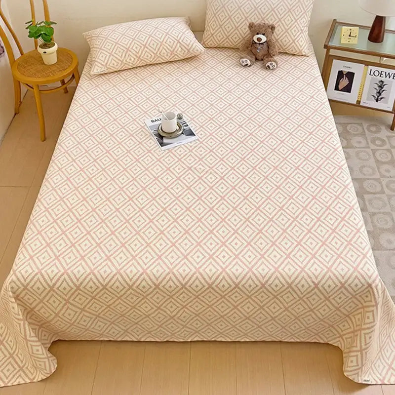 Beige bed sheet set with subtle geometric diamond pattern in soft pink and cream tones for bedroom use