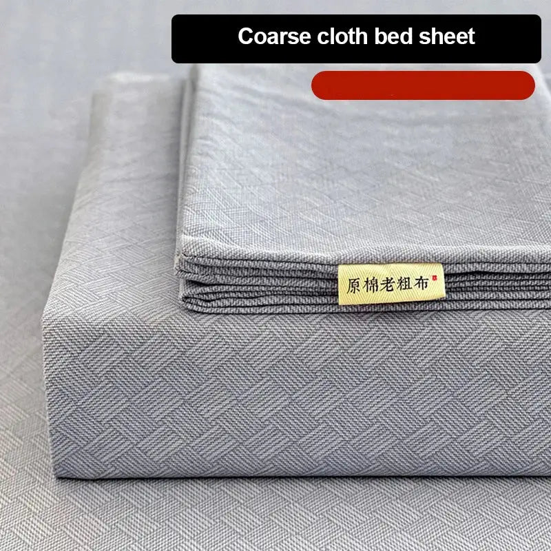 Gray coarse cloth bed sheet with textured weave and yellow label in peach and cream geometric bed sheet set