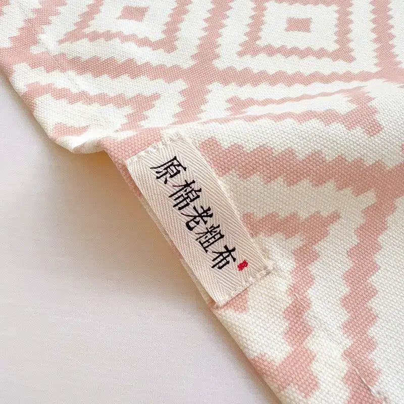 Soft pink and white geometric-patterned cotton bed sheet set with woven texture for bedroom use